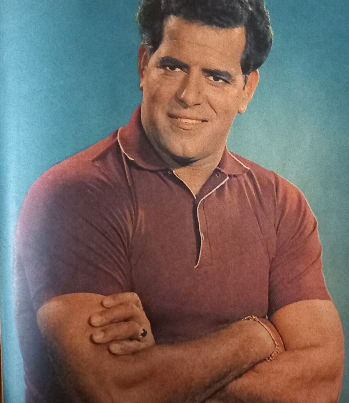 Dara Singh in a maroon polo shirt, arms crossed